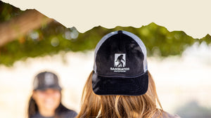 Back of woman wearing black Sasquatch Outdoor hat.