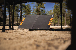Solar panel on a camping ground with trees in the background